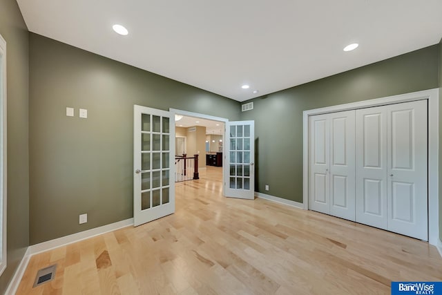 interior space with visible vents, recessed lighting, light wood-style floors, and french doors