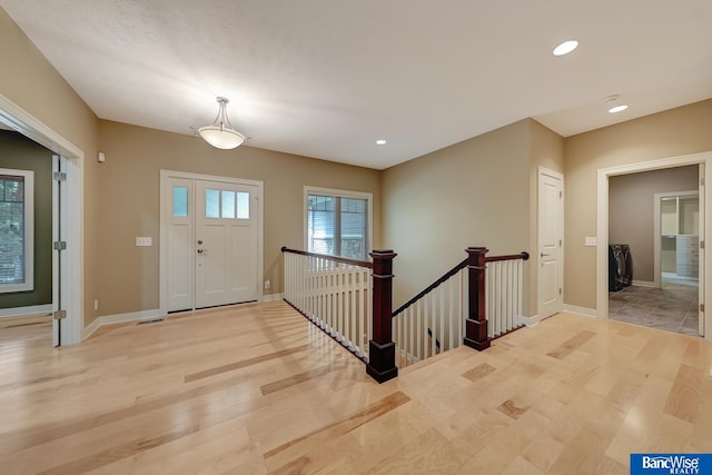 entryway featuring recessed lighting, baseboards, and light wood-type flooring