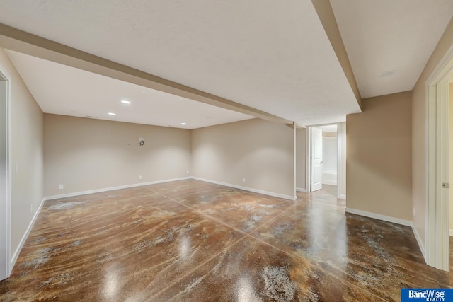 spare room with baseboards