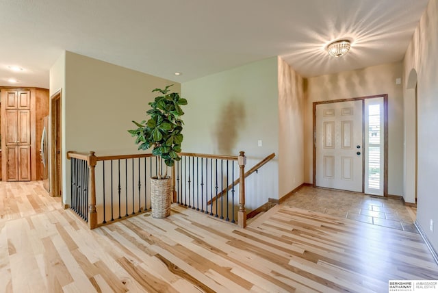 entrance foyer with light wood finished floors and baseboards
