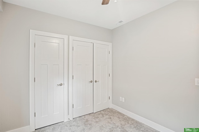 5814 N 27th St, Omaha, NE 68111 - unfurnished bedroom with light colored carpet, baseboards, a closet, and a ceiling fan