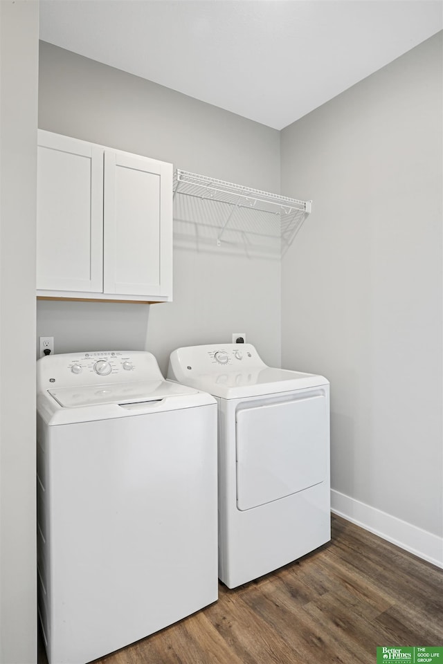 5814 N 27th St, Omaha, NE 68111 - laundry room with washing machine and clothes dryer, cabinet space, dark wood-type flooring, and baseboards