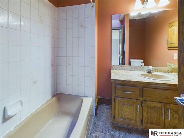 bathroom with toilet and vanity