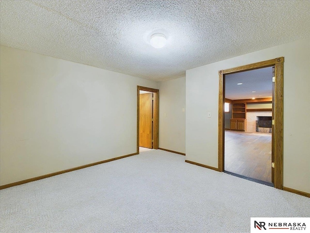 unfurnished bedroom with baseboards, carpet floors, and a textured ceiling