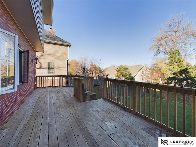 wooden terrace with a lawn