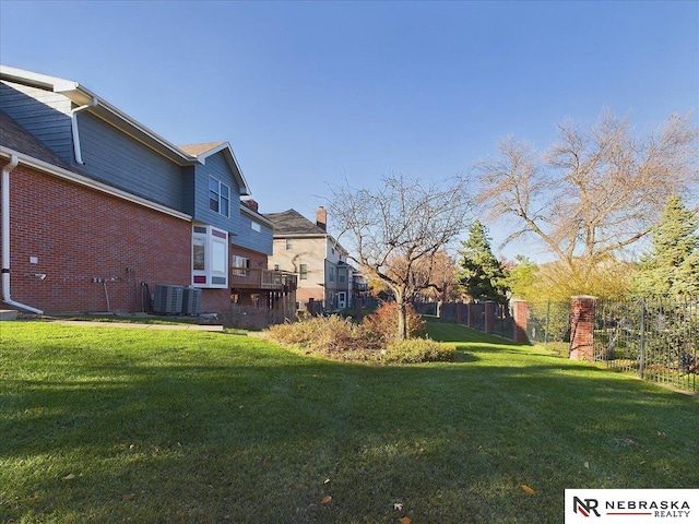 view of yard with fence and central AC unit