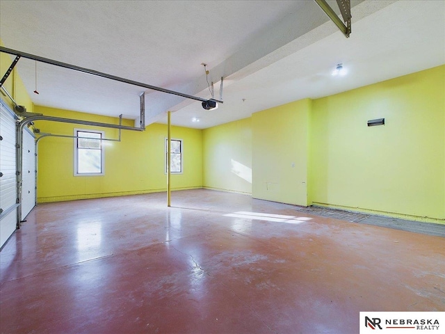 garage with a garage door opener and baseboards