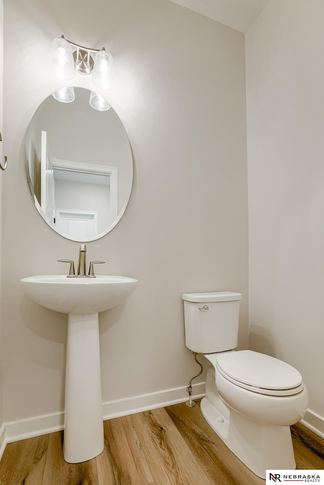 17547 Potter St, Bennington, NE 68007 - bathroom featuring baseboards, toilet, and wood finished floors