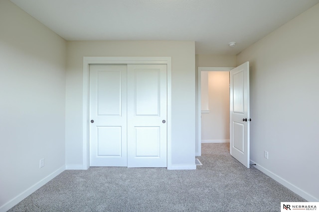17547 Potter St, Bennington, NE 68007 - unfurnished bedroom with carpet flooring, a closet, and baseboards