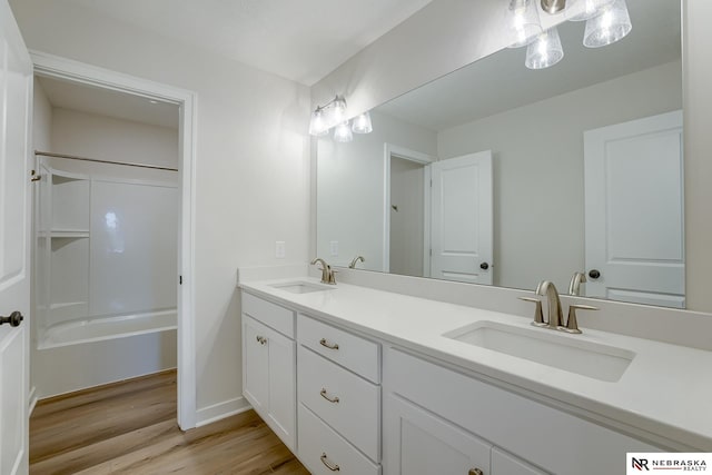 17547 Potter St, Bennington, NE 68007 - bathroom with double vanity, a sink, bathing tub / shower combination, and wood finished floors