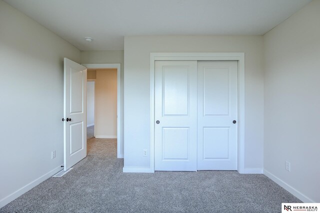 17547 Potter St, Bennington, NE 68007 - unfurnished bedroom with a closet, carpet, and baseboards