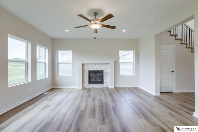 17547 Potter St, Bennington, NE 68007 - unfurnished living room featuring baseboards, a wealth of natural light, light wood-style floors, and a ceiling fan