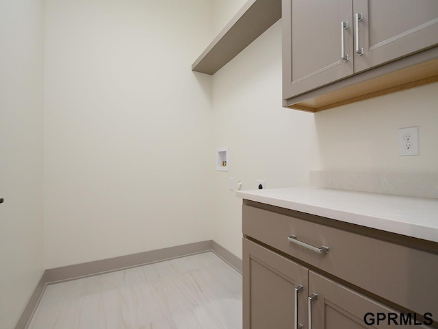 laundry room featuring baseboards, washer hookup, cabinet space, and electric dryer hookup