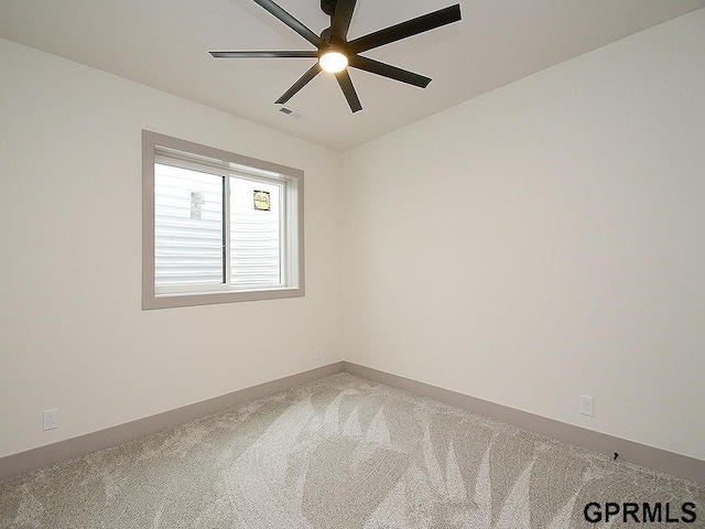 empty room featuring a ceiling fan, carpet, baseboards, and visible vents