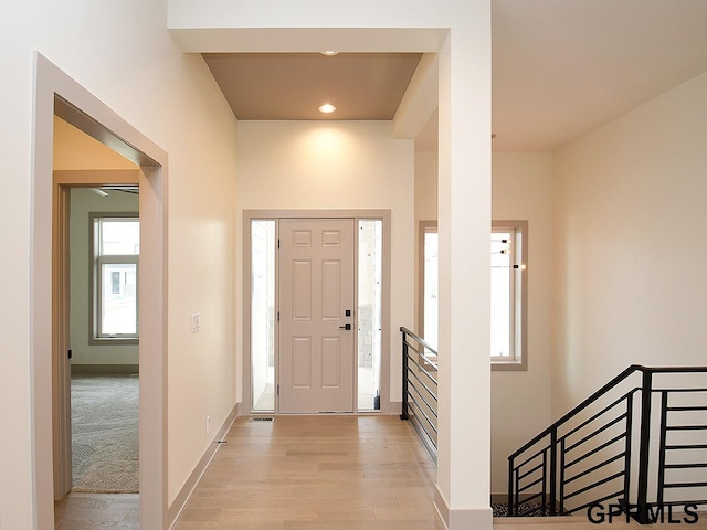 entrance foyer with baseboards, light wood finished floors, and recessed lighting