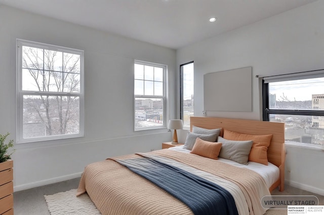 carpeted bedroom featuring baseboards and recessed lighting