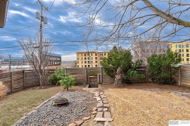 view of yard featuring a fire pit and a fenced backyard
