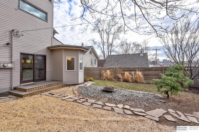 view of yard featuring an outdoor fire pit and fence