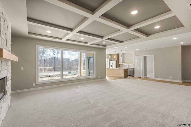 unfurnished living room with coffered ceiling, baseboards, and a fireplace