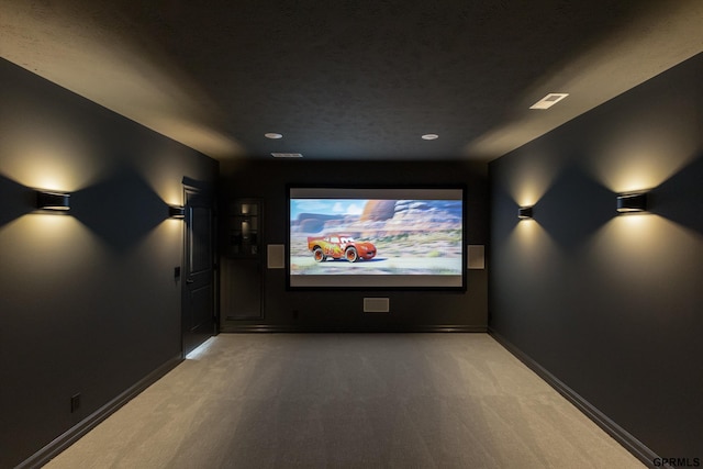 carpeted cinema room with baseboards
