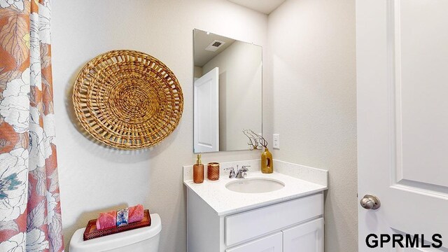 17650 Portal St, Omaha, NE 68136 - bathroom featuring visible vents, toilet, and vanity