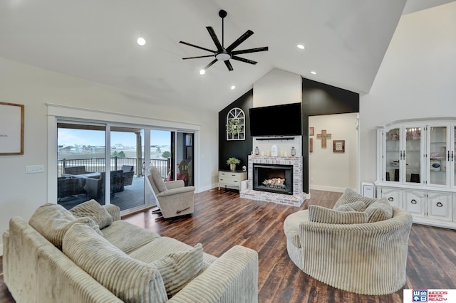 living room with a fireplace, high vaulted ceiling, wood finished floors, and ceiling fan