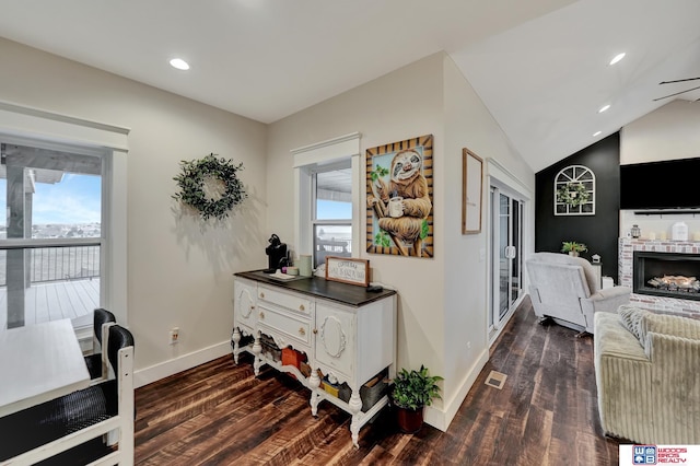 corridor with dark wood-style flooring, baseboards, lofted ceiling, and recessed lighting