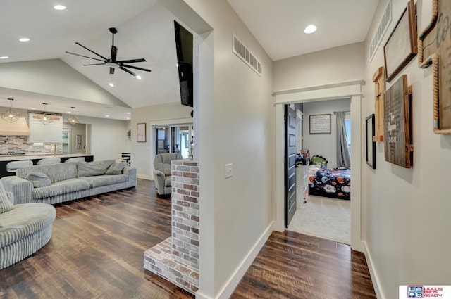 living area featuring high vaulted ceiling, visible vents, baseboards, ceiling fan, and dark wood finished floors