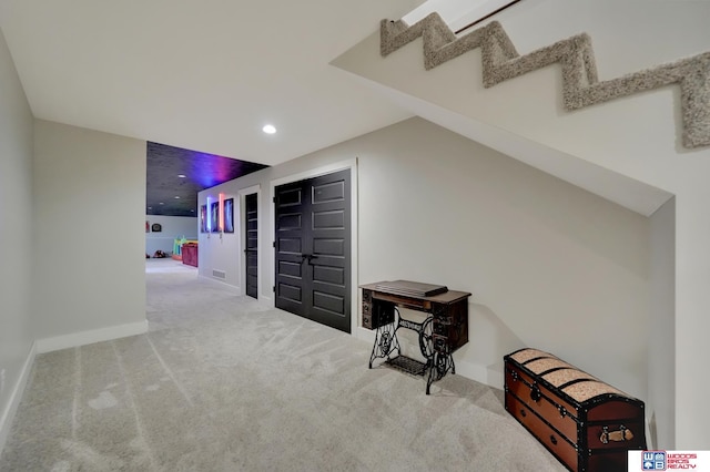 additional living space with baseboards, stairway, recessed lighting, and carpet