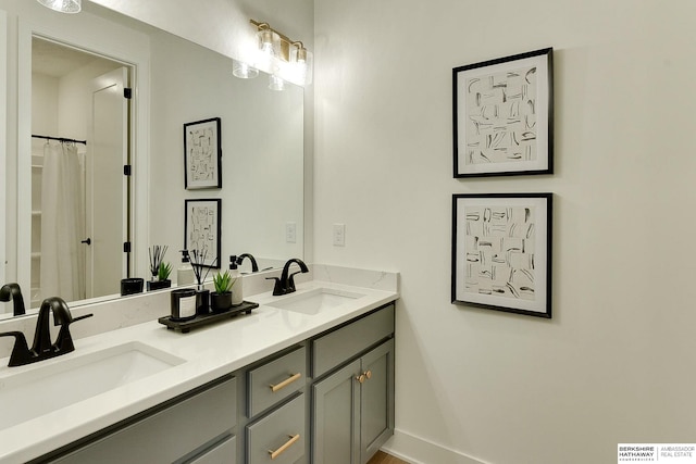 bathroom featuring a sink and double vanity