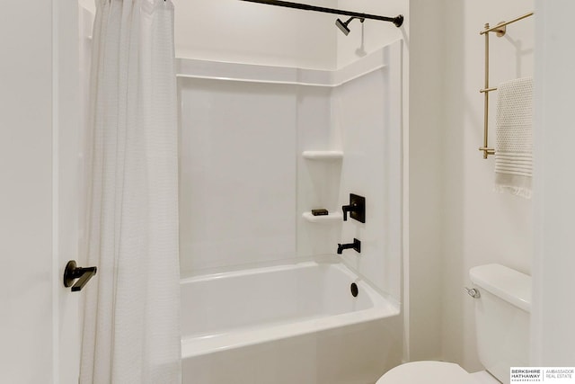 bathroom featuring shower / bath combo and toilet