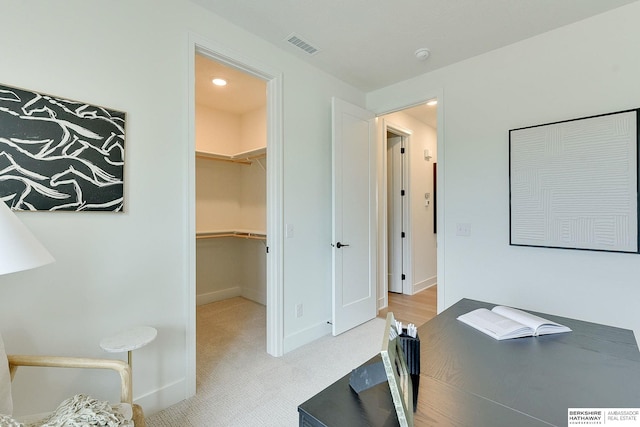 unfurnished office featuring visible vents, baseboards, and carpet floors