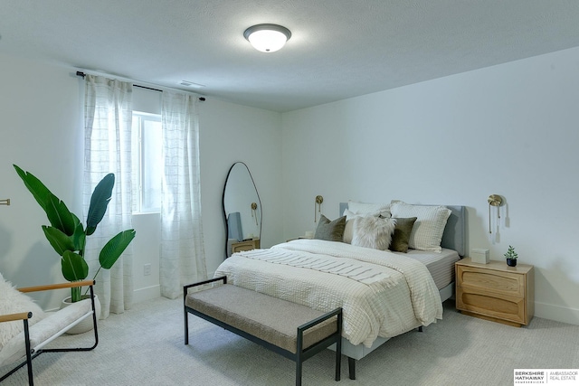 carpeted bedroom featuring baseboards