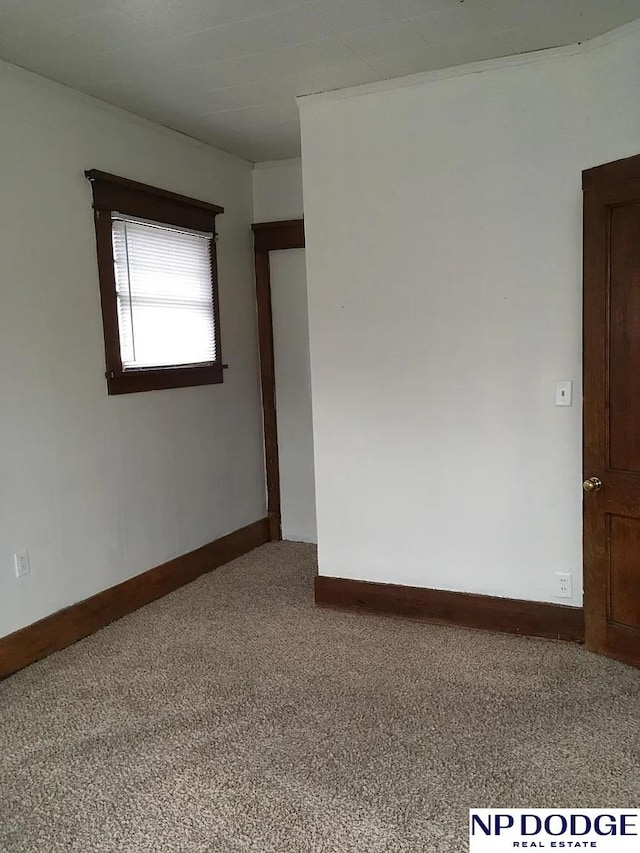 unfurnished room with carpet floors and baseboards