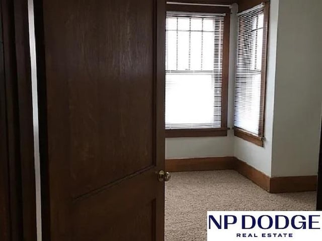 unfurnished room featuring baseboards and a healthy amount of sunlight