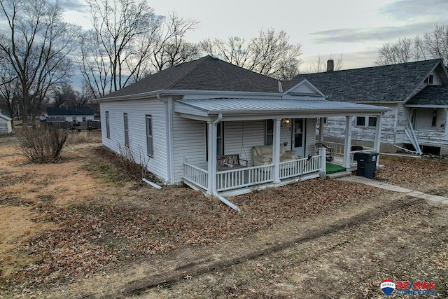 view of front of house with a porch and a shingled roof