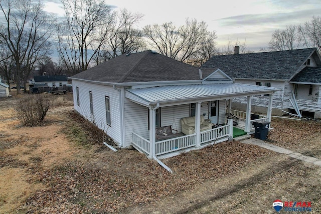 view of front of property featuring a porch and a shingled roof