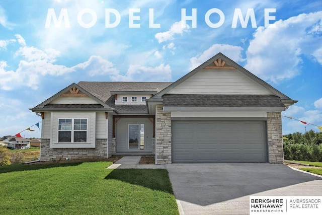 view of front of house with concrete driveway, an attached garage, stone siding, a front yard, and a shingled roof