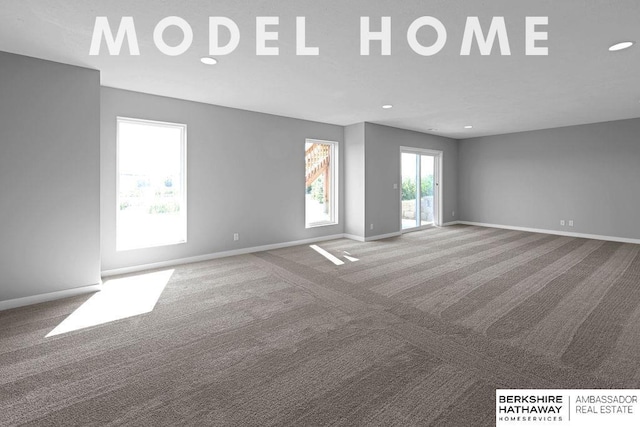 spare room with baseboards, recessed lighting, and carpet