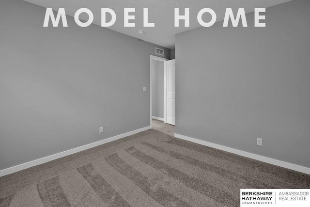 empty room with carpet, baseboards, and visible vents