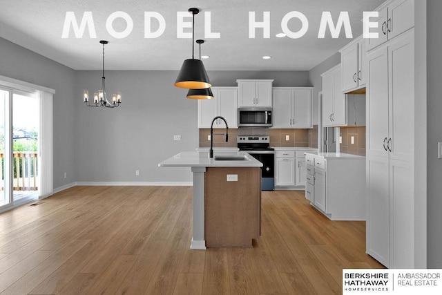 kitchen with a sink, light wood finished floors, range with electric stovetop, stainless steel microwave, and decorative backsplash
