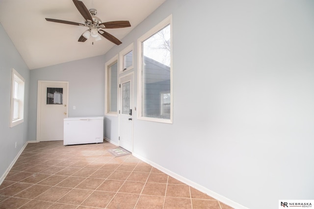 1465 Grant St, Blair, NE 68008 - empty room featuring light tile patterned floors, baseboards, vaulted ceiling, and ceiling fan