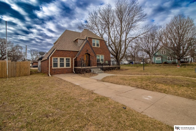 1465 Grant St, Blair, NE 68008 - view of front of property featuring brick siding, a shingled roof, a front lawn, and fence
