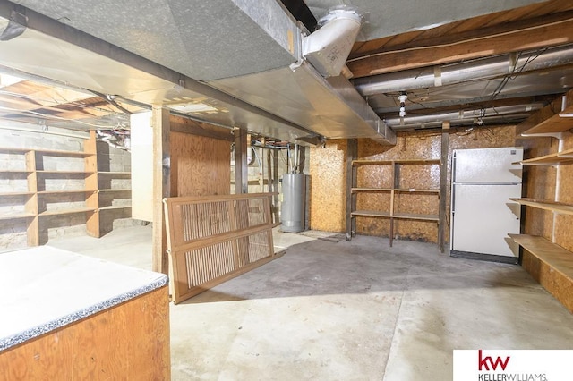 unfinished basement featuring freestanding refrigerator and water heater