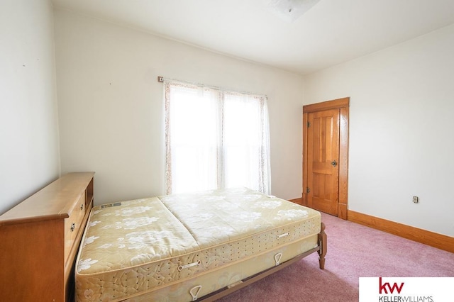 carpeted bedroom featuring baseboards