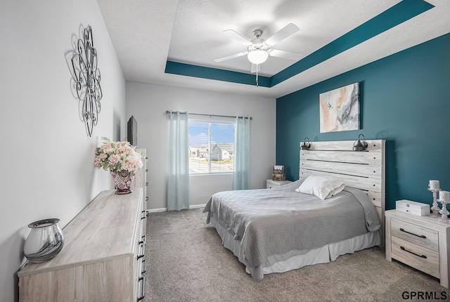 16604 Weber St, Bennington, NE 68007 - bedroom featuring a tray ceiling, light colored carpet, baseboards, a textured ceiling, and ceiling fan