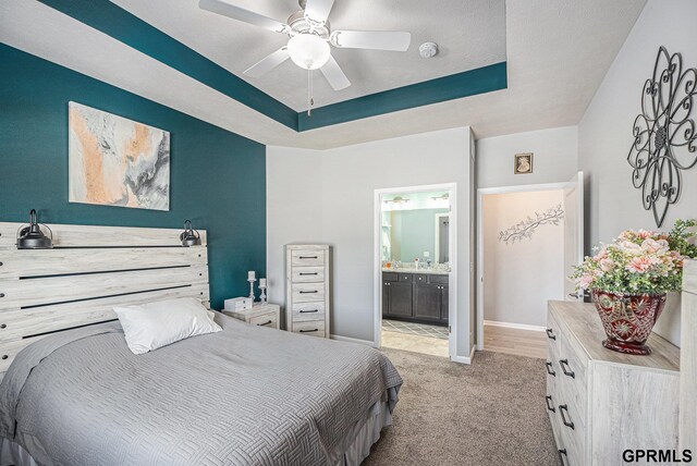 16604 Weber St, Bennington, NE 68007 - bedroom featuring baseboards, ceiling fan, a raised ceiling, ensuite bath, and light colored carpet