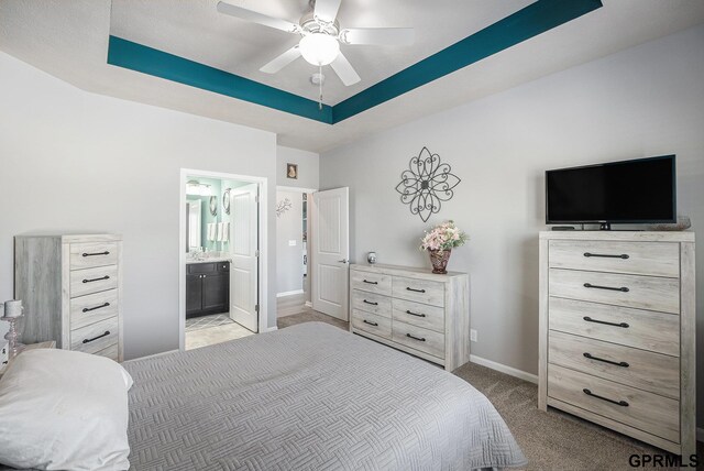16604 Weber St, Bennington, NE 68007 - bedroom with a tray ceiling, a ceiling fan, baseboards, ensuite bathroom, and light colored carpet
