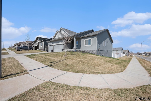 16604 Weber St, Bennington, NE 68007 - view of front of home featuring fence, a residential view, a front yard, and an attached garage