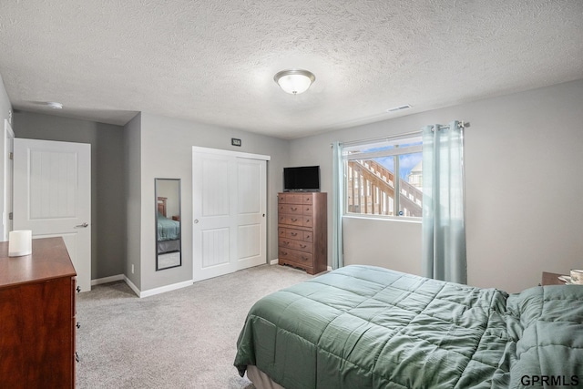 16604 Weber St, Bennington, NE 68007 - bedroom with baseboards, a textured ceiling, visible vents, light carpet, and a closet